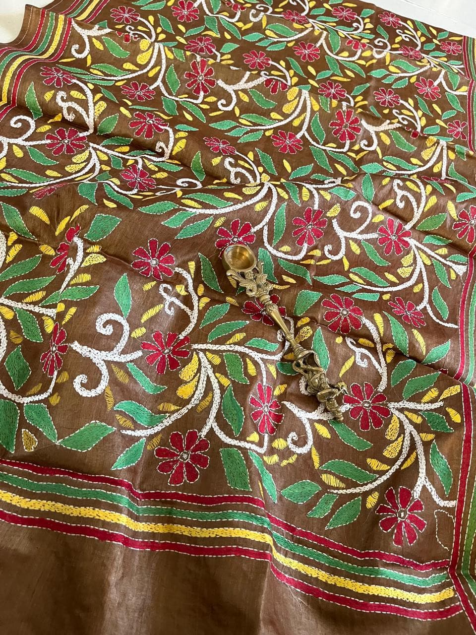 A hand-embroidered fabric piece printed at Ajanta Arts